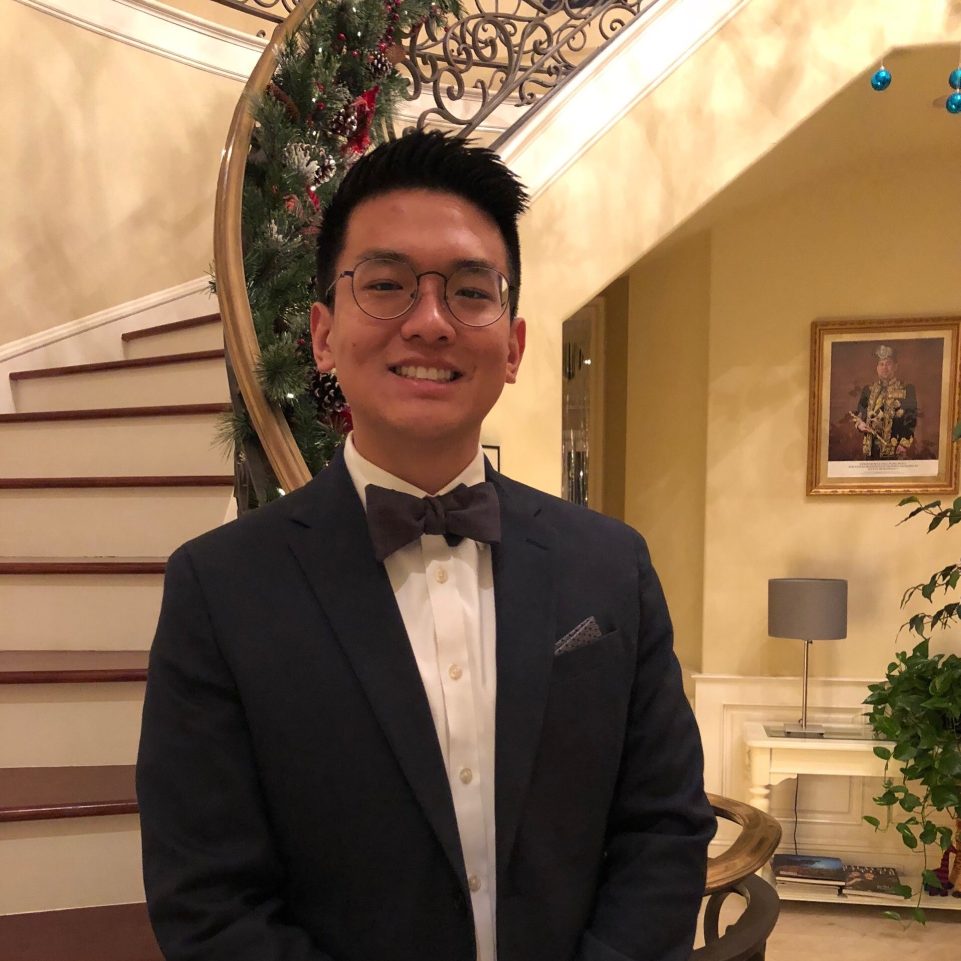 Asian male in a tux smiling